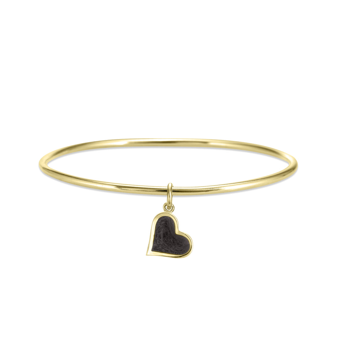 single bangle cremation bracelet in 14k yellow gold with dainty heart charm shown from the front