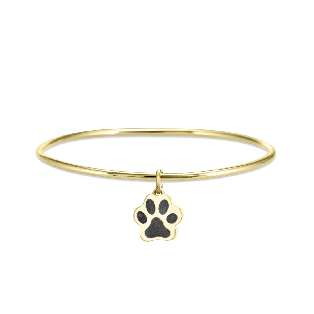 single bangle cremation bracelet in 14k yellow gold with paw print charm shown from the front