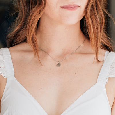 A model wearing close by me jewelry's Single Setting Circle Cremation Necklace in Sterling Silver