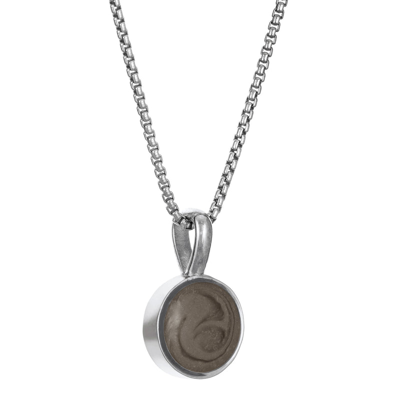The 14K White Gold Single Setting Circle Cremains Pendant designed and set with cremains by close by me jewelry from the side