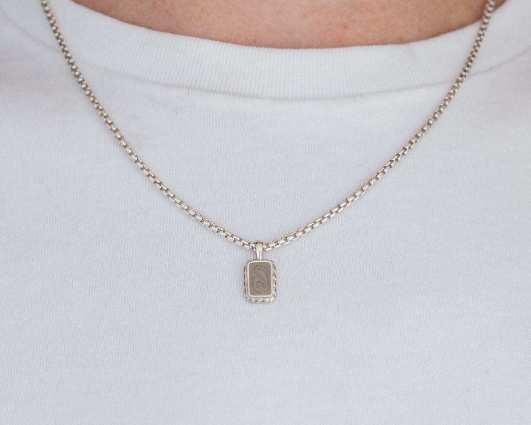 close by me jewelry's sterling silver small cable memorial necklace with cremains being worn by a male model in a white t shirt