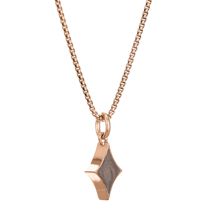 This photo shows close by me jewelry's Small Diamond Charm with ashes design in 14K Rose Gold from the side