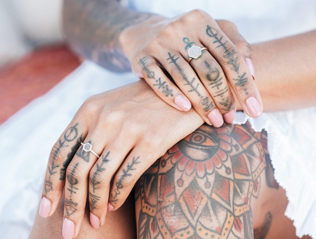 Pictured here are two sizes of the Hexagonal Stacking Cremation Rings in Sterling Silver and 14K Yellow Gold, designed by close by me jewelry, on a model's hands