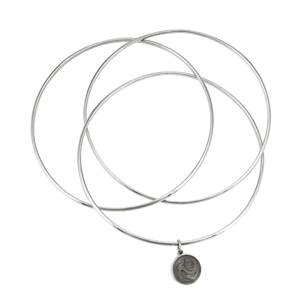 Sterling silver interlocking bangle cremation bracelet with a 10mm ashes dome charm, shown from the top