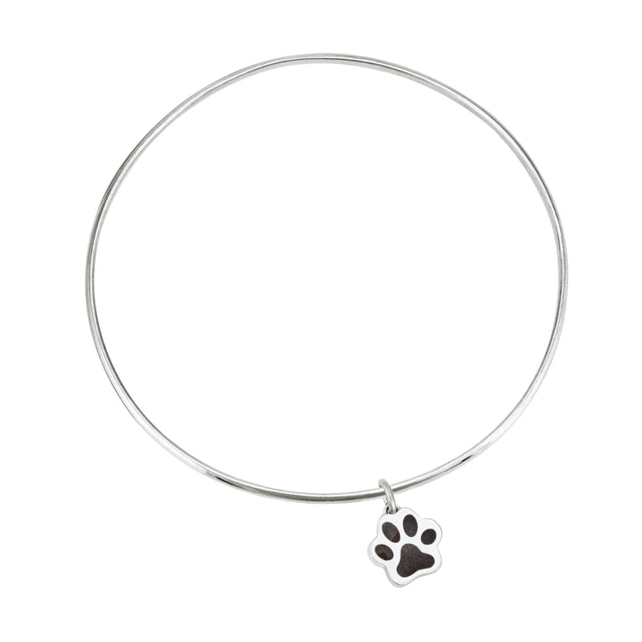 Sterling silver single bangle cremation bracelet with paw print ashes charm shown from the top