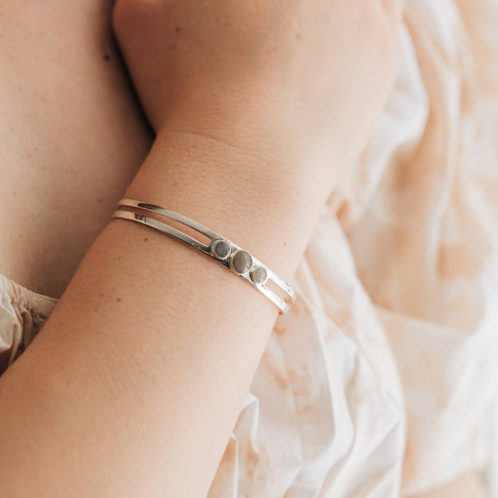 sterling silver three setting cremation cuff bracelet shown on model's wrist closeup
