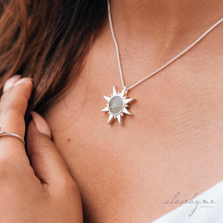 A close up showing the Sterling Silver Sun Cremains Pendant designed by close by me jewelry around a model's neck