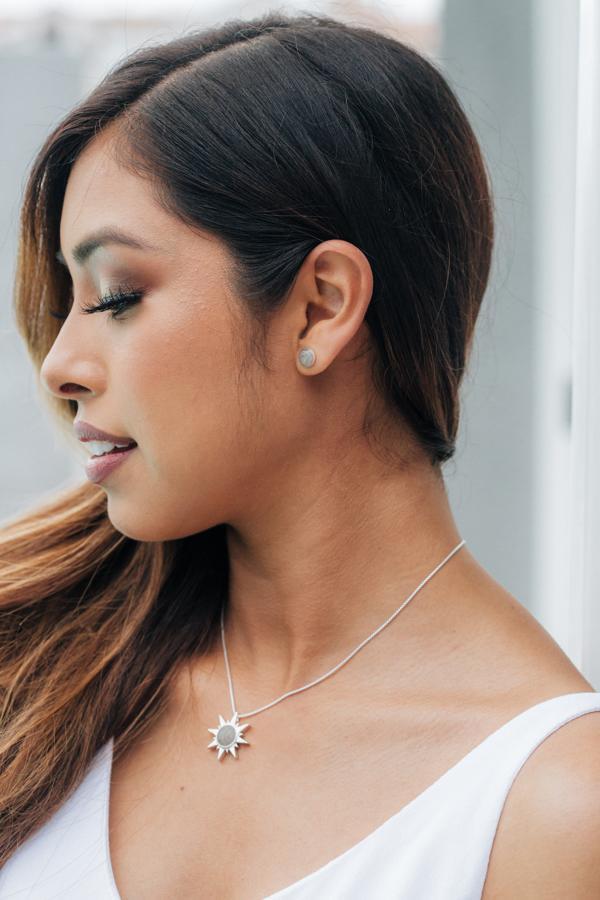 A tan model with dark hair wearing close by me jewelry&
