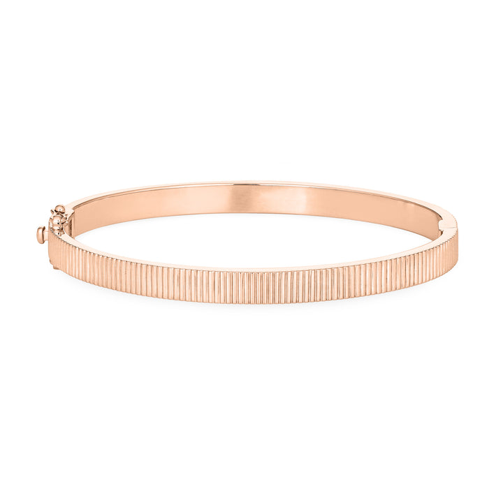 Close By Me's Tessa Bangle Cremation Bracelet in 14K Rose Gold lays flat and in a closed position with the cremation setting on the side facing away from the camera against a solid white backdrop.