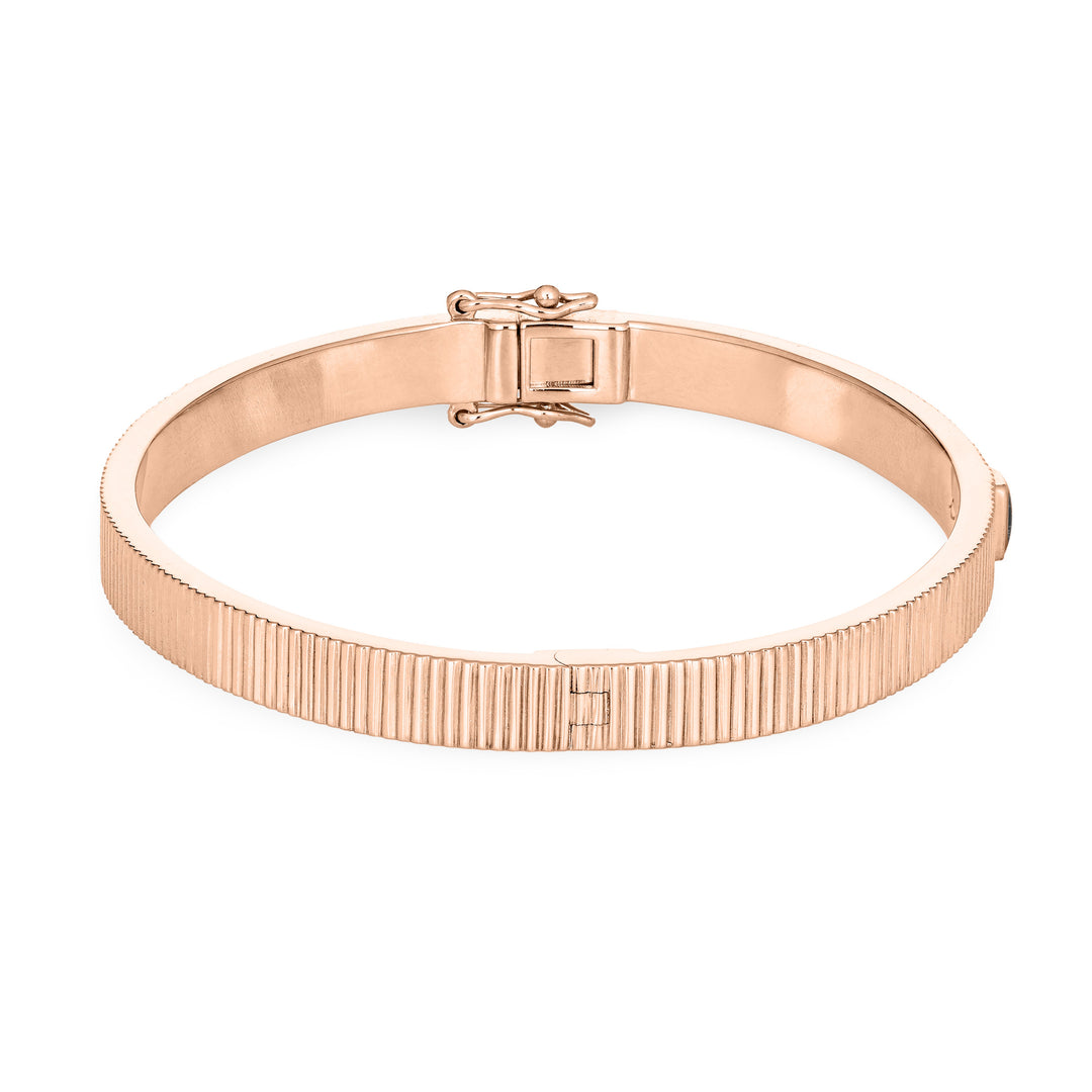 Close By Me's Tessa Bangle Cremation Bracelet in 14K Rose Gold lays flat and turned to the right in a closed position against a solid white backdrop.