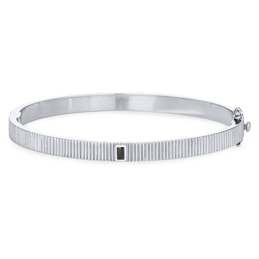 Close By Me's Tessa Bangle Cremation Bracelet in 14K White Gold lays flat and facing forward in a closed position against a solid white backdrop.