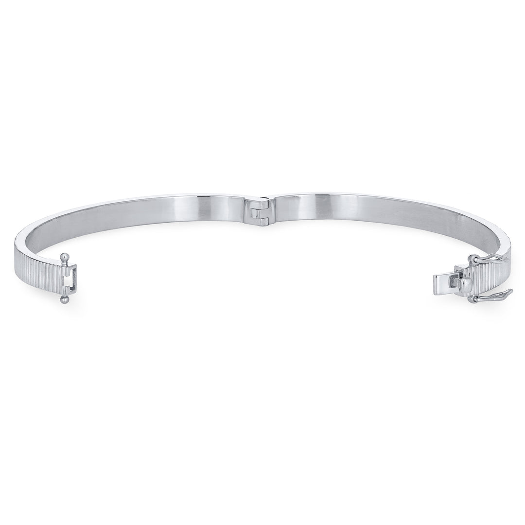 Close By Me's Tessa Bangle Cremation Bracelet in 14K White Gold lays flat and turned to the left in an open position against a solid white backdrop.
