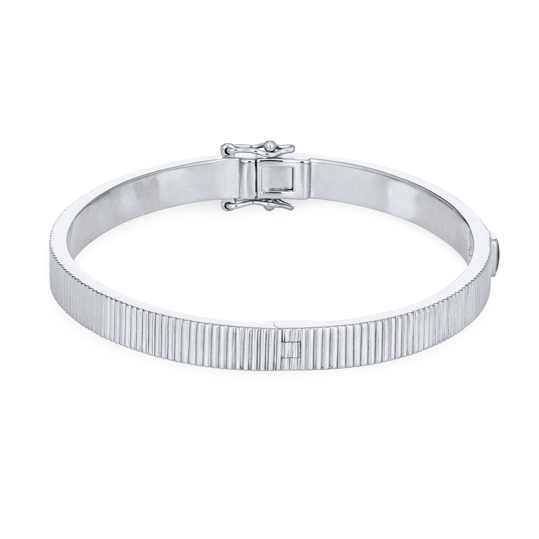Close By Me's Tessa Bangle Cremation Bracelet in 14K White Gold lays flat and turned to the right in a closed position against a solid white backdrop.