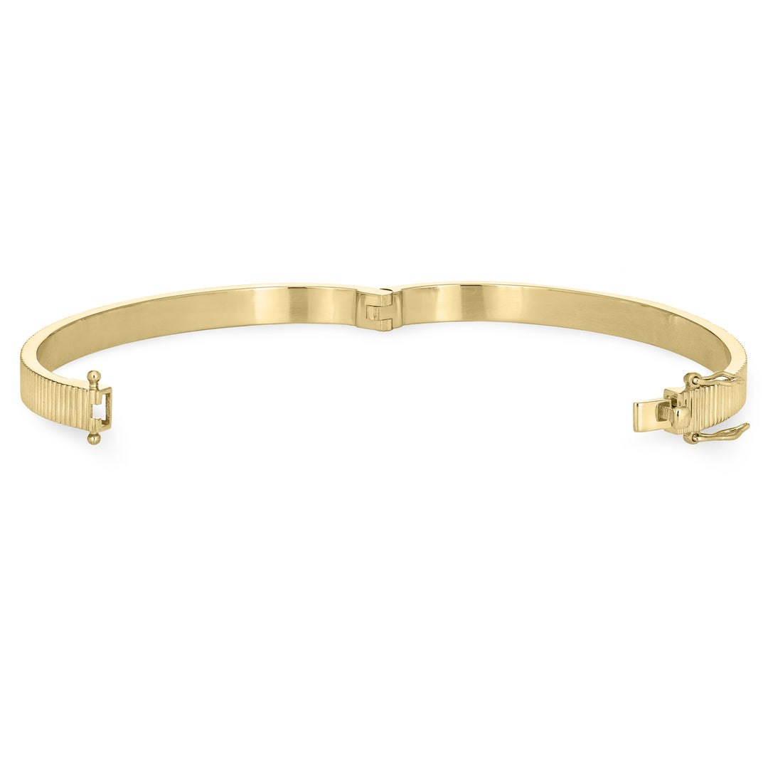 Close By Me's Tessa Bangle Cremation Bracelet in 14K Yellow Gold lays flat and turned to the left in an open position against a solid white backdrop.