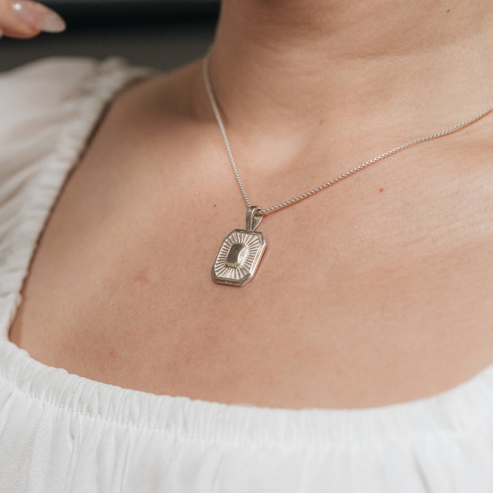 A close-up, cropped photograph of Close By Me's Tessa Cremation Necklace being worn around a woman's neck.
