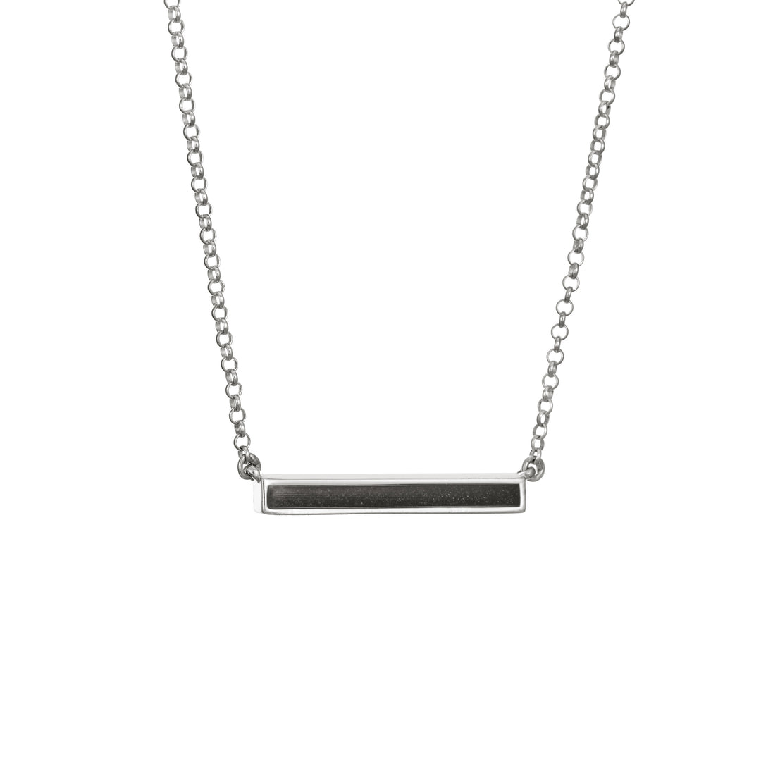 An angled photo showing the ashes setting in the sterling silver thin lateral bar memorial necklace
