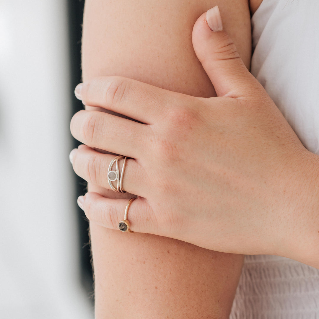 a ring with cremains being worn by a model in sterling silver in close by me's three band cremated remains ring design