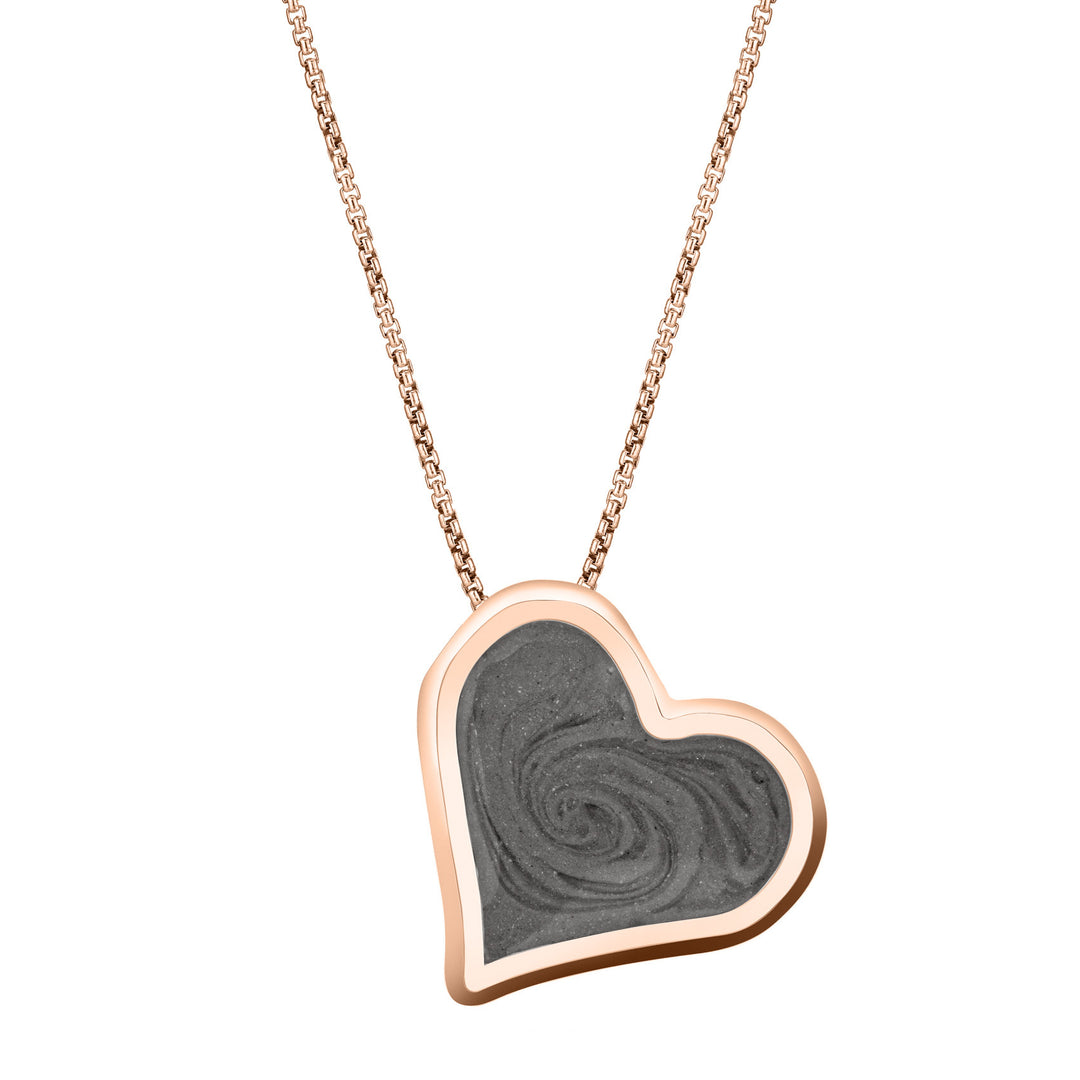 The 14K Rose Gold Heart Shaped Pendant with ashes, designed by close by me with a hidden bail to make the piece tilt, from the front