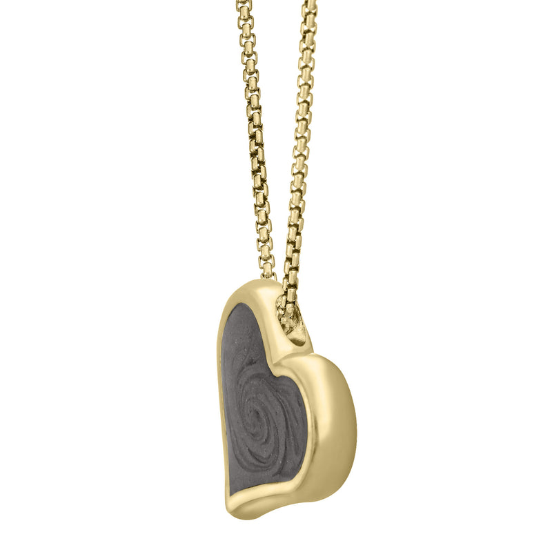 The 14K Yellow Gold Heart Shaped Ashes Pendant, designed by close by me with a hidden bail to make the piece tilt, from the side