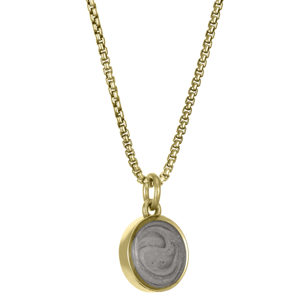 This photo shows the 8mm Dome Ashes Necklace designed and set by close by me jewelry in 14K Yellow Gold from the side