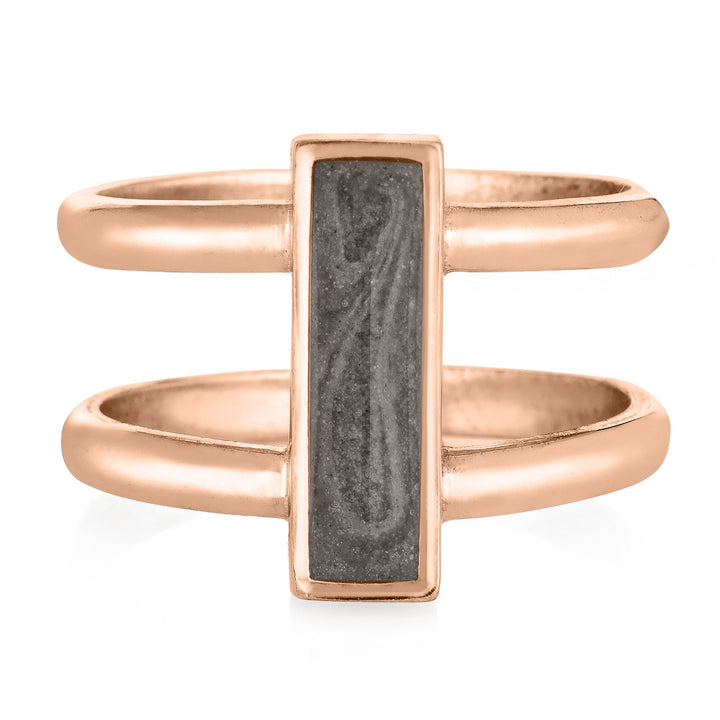 Pictured here is close by me's 14K Rose Gold Bar Cremation Ring from the front to show its gray ashes setting and how it attaches to the double-bands