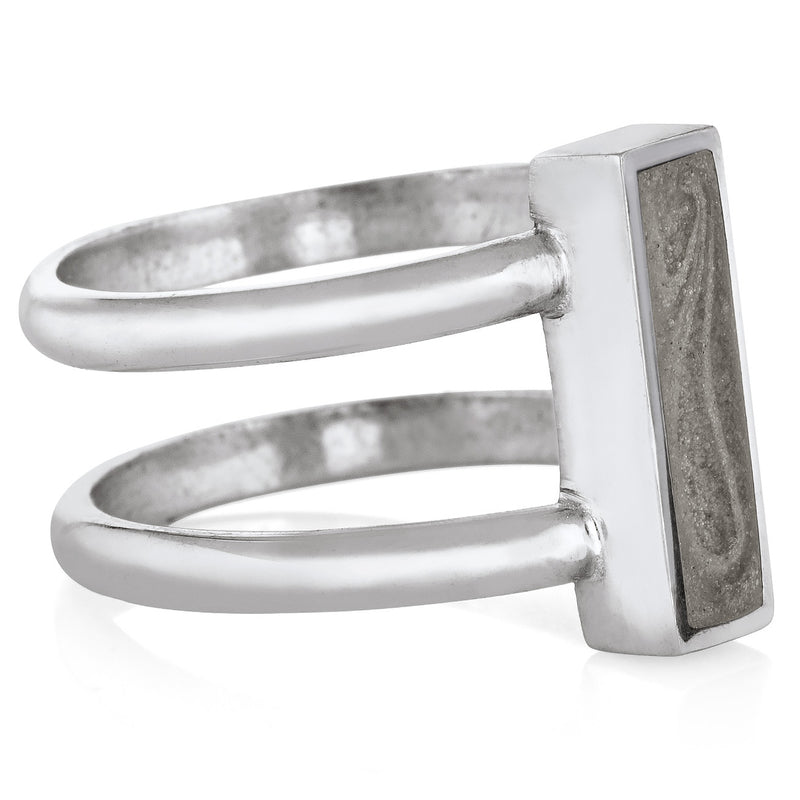 Pictured here is the 14K White Gold Bar Ashes Ring by close by me jewelry from the side to show the thickness of its bezel, light grey ashes setting, and how the bands hold the bezel