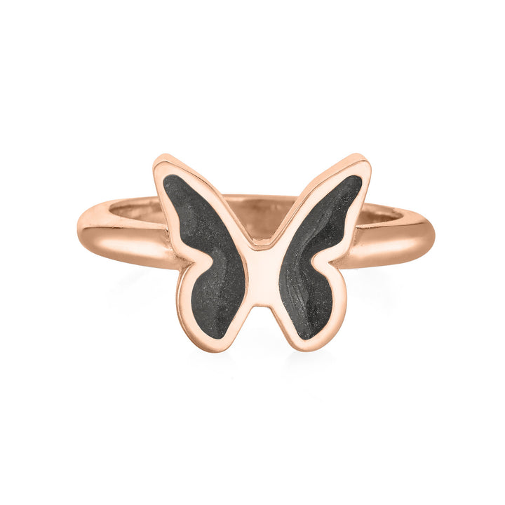 Pictured here is close by me jewelry's 14K Rose Gold Butterfly Cremation Ring with a dark grey ashes setting in each wing from the front