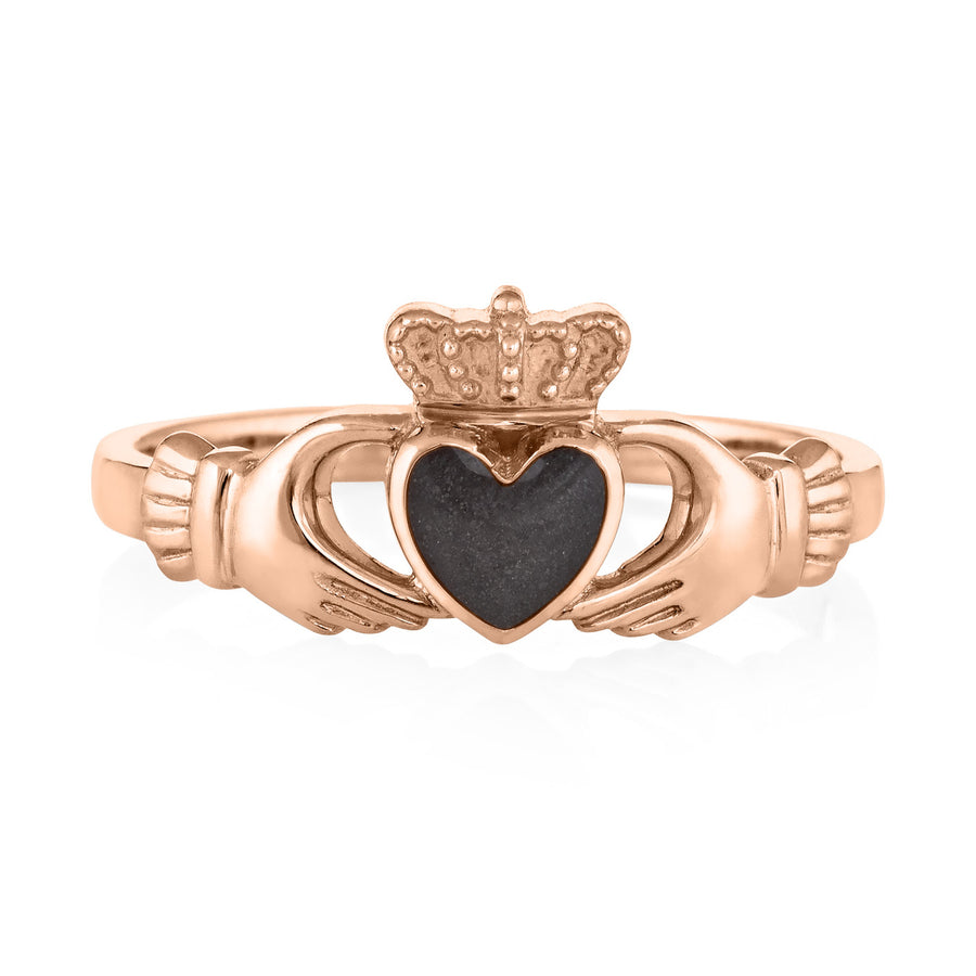 This photo shows the 14K Rose Gold Claddagh Cremation Ring design by close by me jewelry from the front to show its dark grey ashes setting