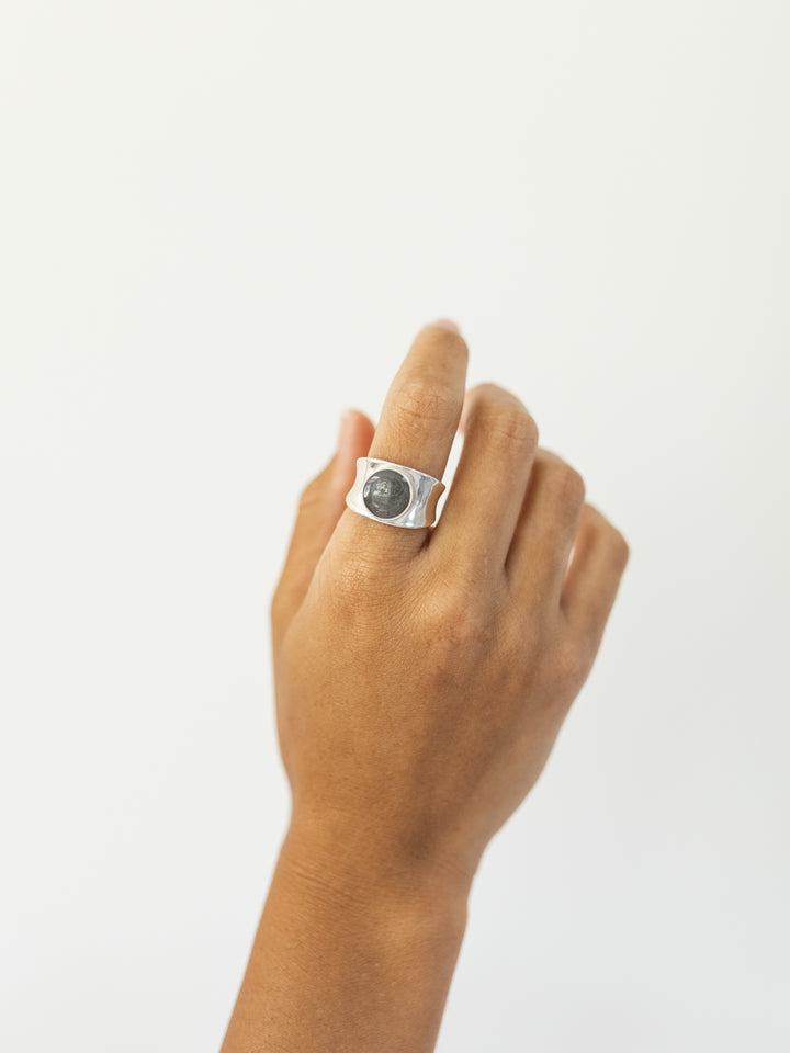 This photo shows a different angle of the Sterling Silver Concave Band Ring with cremains designed by close by me jewelry and worn on a model's index finger