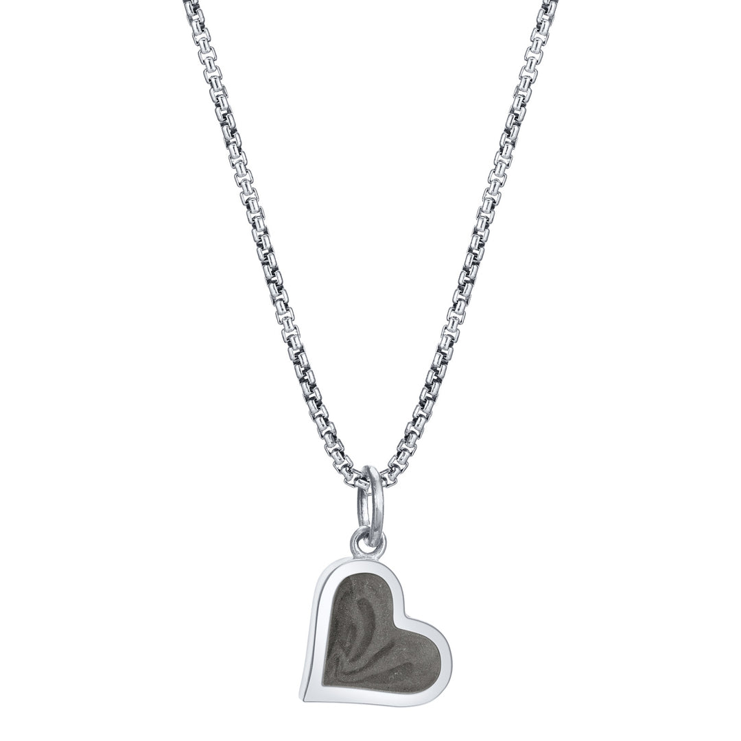 This photo shows the Dainty Heart Charm with ashes designed in 14K White Gold by close by me jewelry on a chain from the front