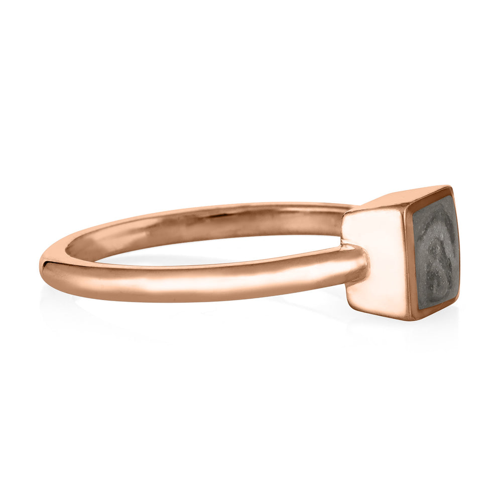 Pictured here is the Dainty Square Cremation Ring in 14K Rose Gold from the side to show the thickness of the bezel and band