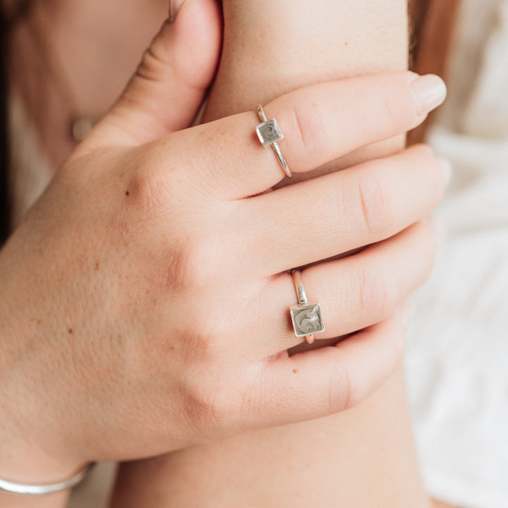 This photo shows a model wearing Sterling Silver Stacking Square Rings set with ashes by close by me jewelry in two different sizes