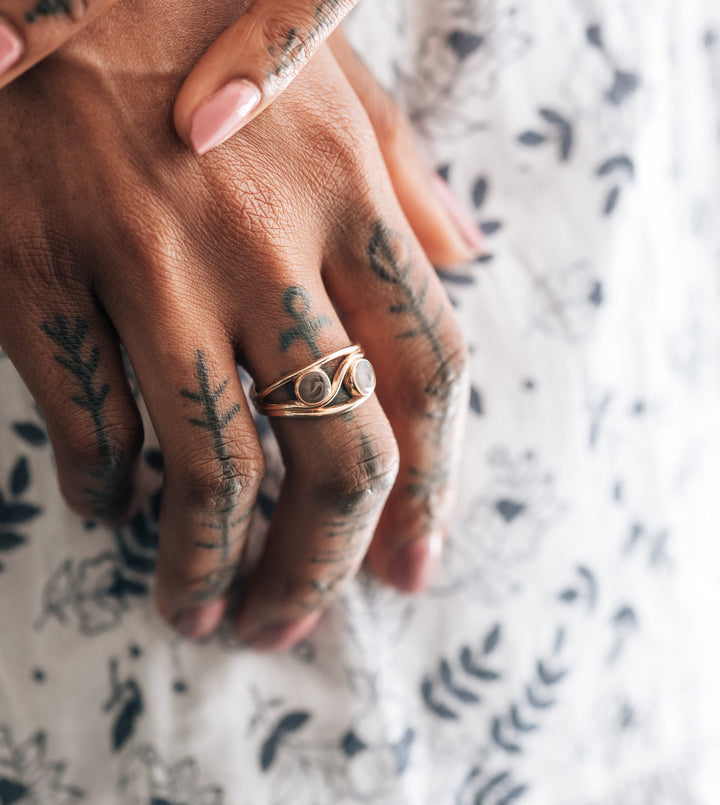 This photo shows the 14K Rose Gold Double Setting Cremation Ring by close by me jewelry being worn on a model's middle finger