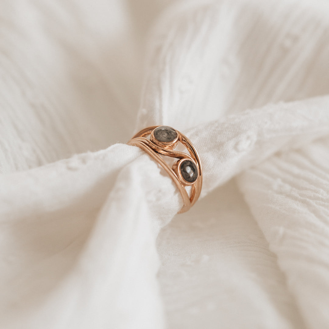 This photo shows the Double Setting Cremation Ring design by close by me jewelry in 14K Rose Gold on a lightly textured soft white cloth