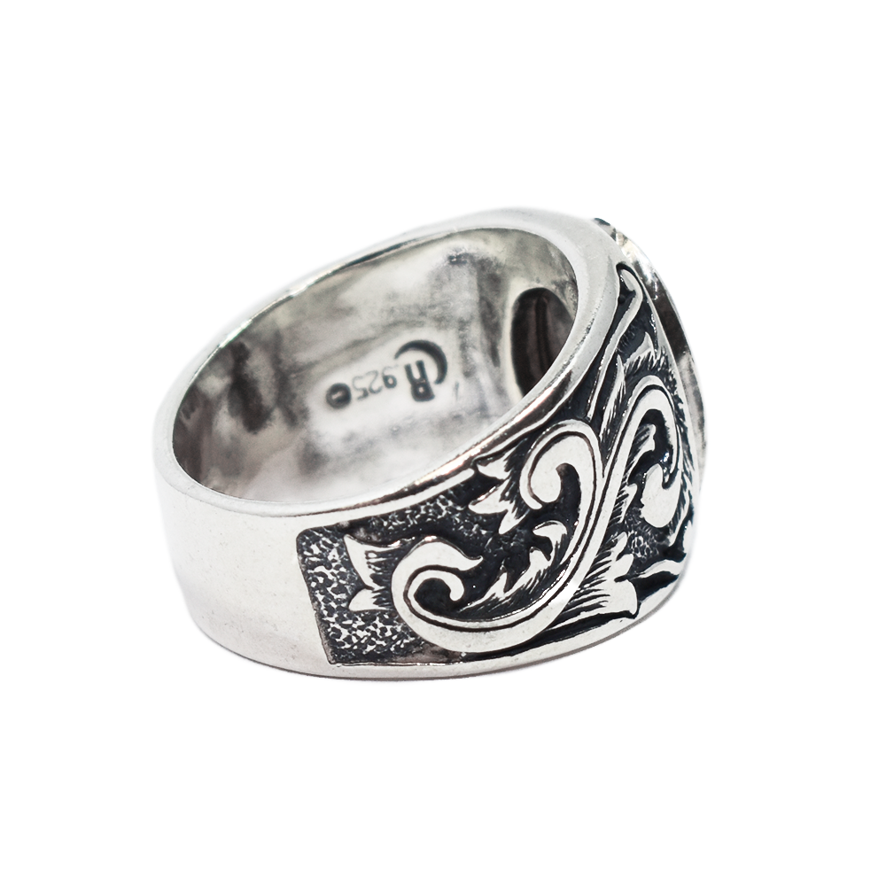 Pictured here is the close by me jewelry's Floral Art Deco Band Cremation Ring in Sterling Silver from the back and turned to a slight angle to show the inside of the band and back of the band design detail