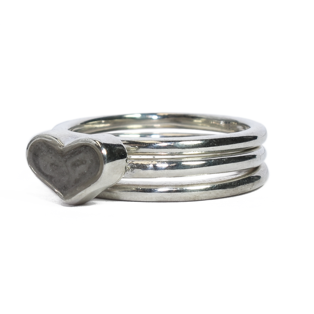 Pictured here is the Sterling Silver Heart Ashes Stacking Ring Set designed and set with cremains by close by me jewelry from the front at an angle to the left