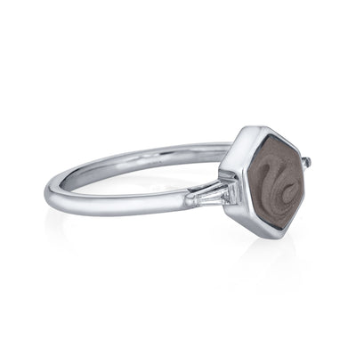 Pictured here is close by me jewelry's 14K White Gold Hexagon White Baguette Diamond Band Ashes Ring from the side to show its medium gray ashes setting and the thickness of its bezel