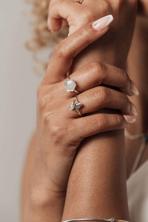 A picture of a model wearing the Sterling Silver Large Hexagon Stacking Ring and 14K Yellow Gold Double Setting Split Shank Ring designs by close by me