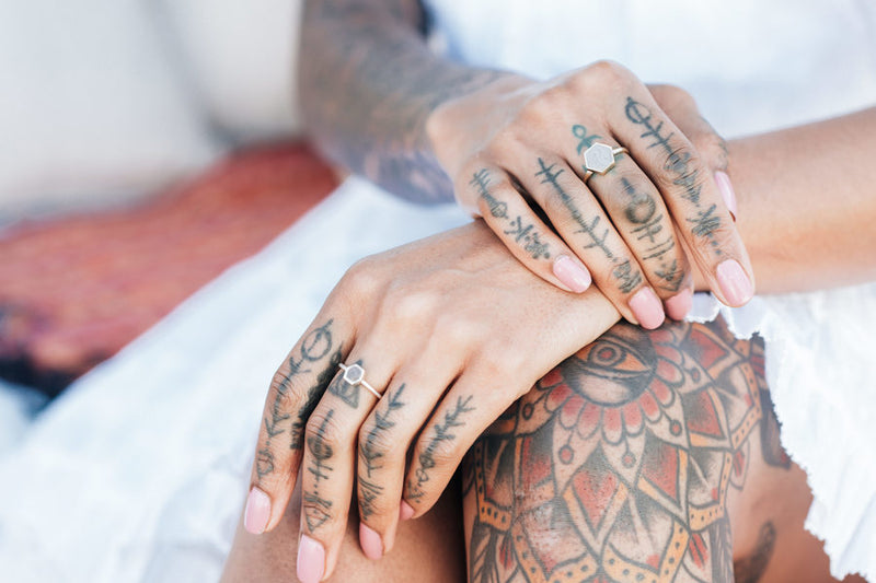 A model wearing the Sterling Silver Small Hexagon and 14K Yellow Gold Large Hexagon Stacking Rings by close by me
