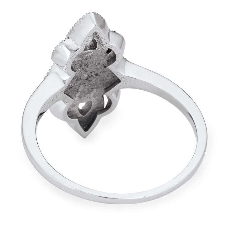 Pictured here is a close-up back view of Close By Me Jewelry's vintage-style World War II Cremation Ring in 14K White Gold set against a solid white background. This version of the ring has a larger oval bezel (not shown) containing solidified cremated remains.