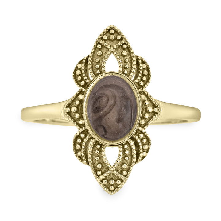Pictured here is a close-up front view of Close By Me Jewelry's vintage-style World War II Cremation Ring in 14K Yellow Gold set against a solid white background. This version of the ring has a larger oval bezel containing solidified cremated remains. The ashes setting in this photo is medium gray in color and features a distinct swirl pattern.