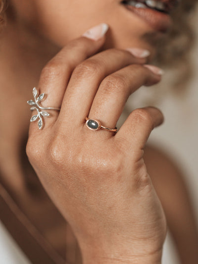 This photo shows a model wearing the Lateral Oval Stacking Ashes Ring design by close by me jewelry on her ring finger in 14K Rose Gold
