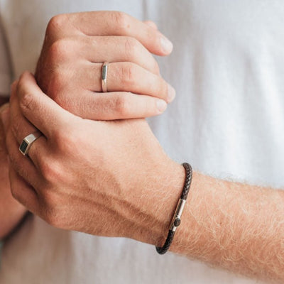 This photo shows the Leather Cord Cremains Men's Bracelet on a male model's wrist