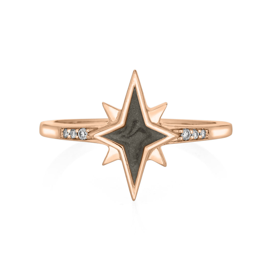 Pictured here is close by me jewelry's North Star Champagne Diamond Band Cremation Ring in 14K Rose Gold from the front to show its medium gray ashes setting and three round diamonds set into its band.
