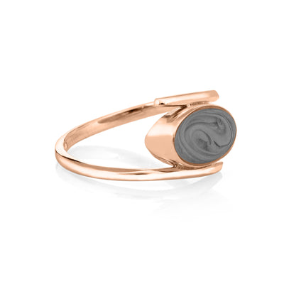 Pictured here is the 14K Rose Gold Oval Spiral Band Cremation Ring design in 14K Rose Gold by close by me jewelry from the side to show its medium grey ashes setting and thickness of the bezel