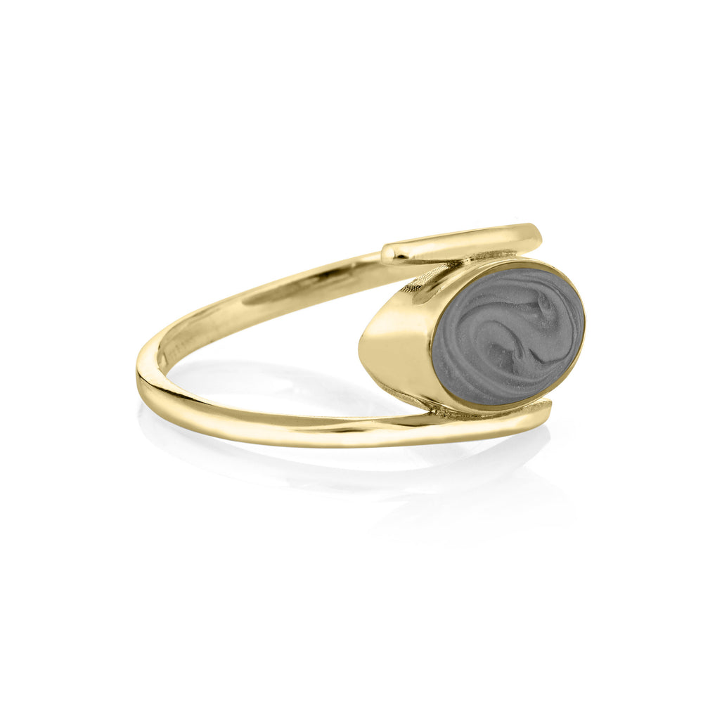 This photo shows the 14K Yellow Gold Oval Spiral Band Ashes Ring design by close by me jewelry from the side to showcase its medium gray cremation setting and thickness of the bezel