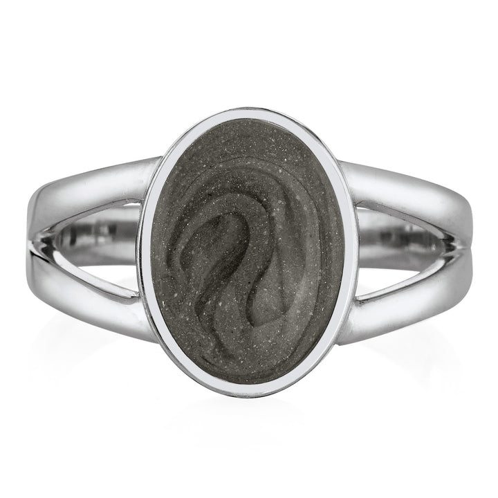 Pictured here is close by me jewelry's 14K White Gold Oval Split Shank Ashes Ring design from the front to show its medium grey cremation setting and split band