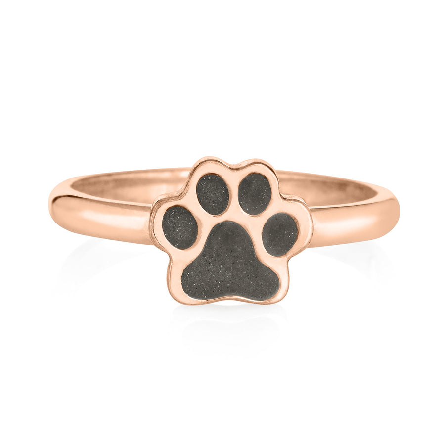 Pictured here is the 14K Rose Gold Paw Print Stacking Cremation Ring design by close by me jewelry from the front to show its gray ashes setting