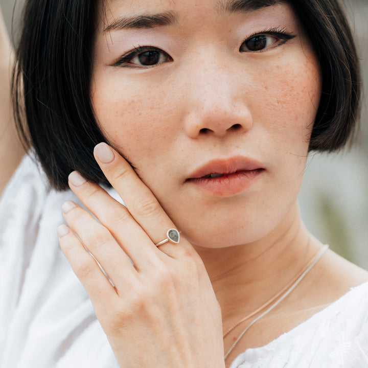 Pictured here is a model wearing the Sterling Silver Pear Stacking Ring design by close by me jewelry