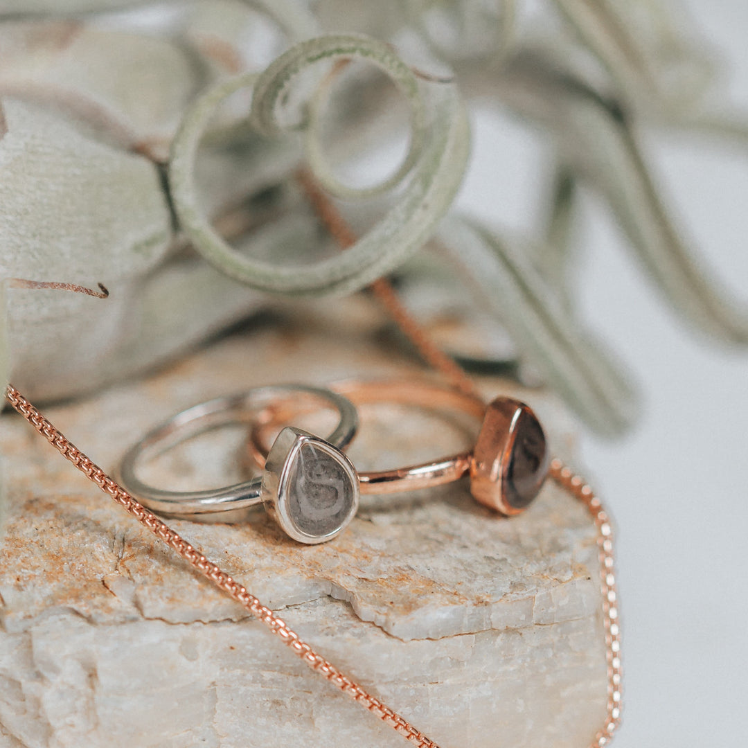 Pictured here is the Pear Stacking Ring design by close by me jewelry in both Sterling Silver and 14K Rose Gold